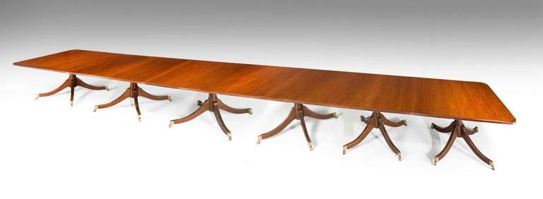 A fine quality mahogany six pillar banqueting table of George III design, the gun barrel supports with four splayed legs, the top with a reeded edge and mahogany cross banding, mid-20th century.

The price of dining tables, Richard Gillow wrote in