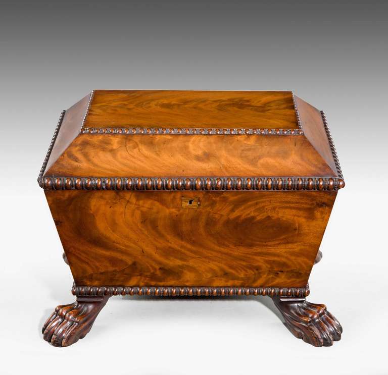 Regency period mahogany wine cooler, the interior with a central section flanked by two lidded compartments, the whole with well figured timbers standing on finely carved feet.

