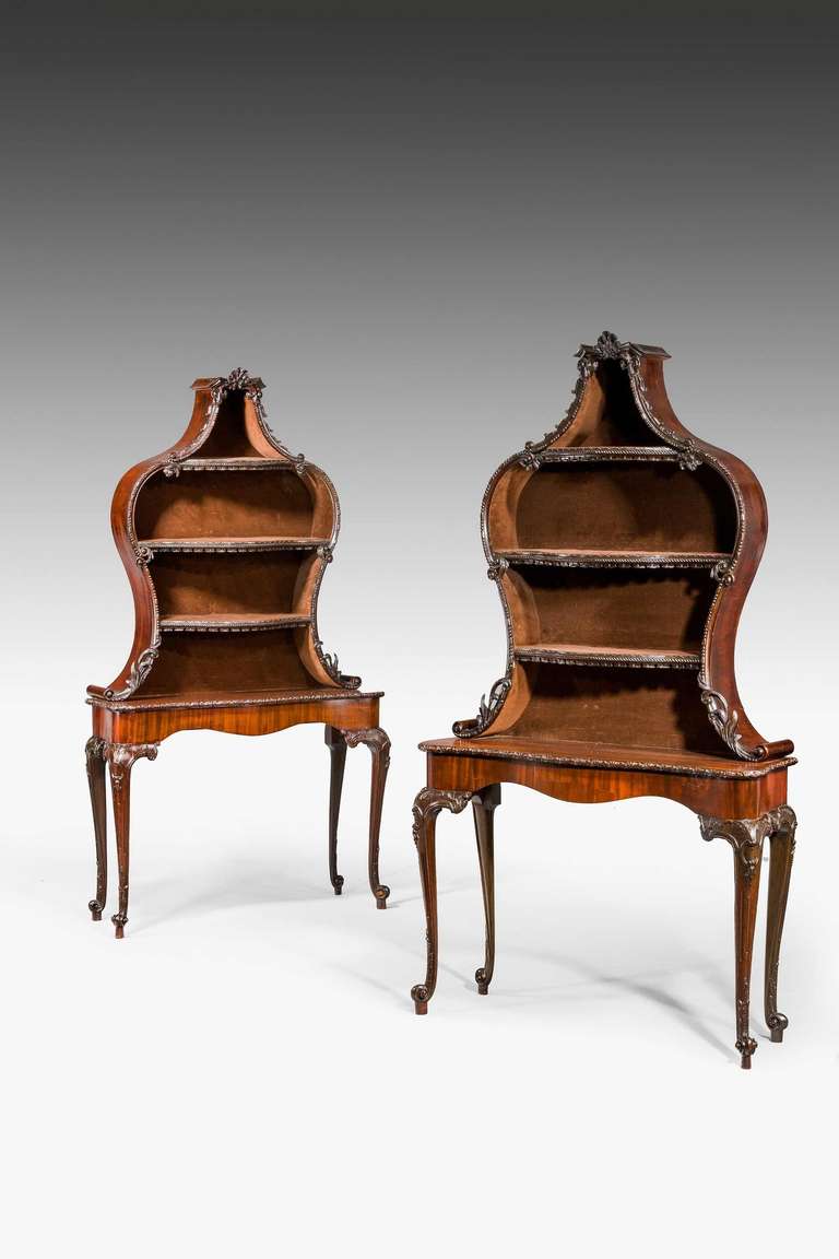 A most unusual pair of Late 19th century Display Tables, the lower sections mid 18th century on strongly shaped cabriole supports with a finely carved edge. The top sections made in the 19th century to take objects, also beautifully carved at the