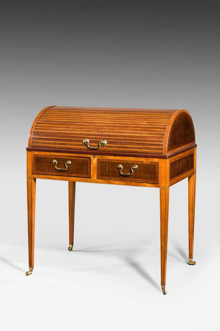 A George III period mahogany cylinder top desk, the main structure in satinwood and Harewood, the drawer fronts beautifully figured in harewood with Kingwood banding with fine line inlay to the upright supports. The interior with two drawers and