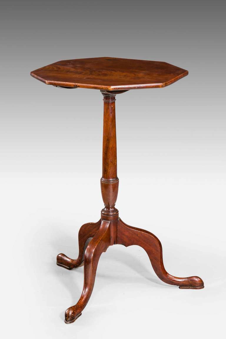 A George III period mahogany octagonal topped tripod/tilt table, the top with finely figured timbers, turned circular support over pad feet.

RR.