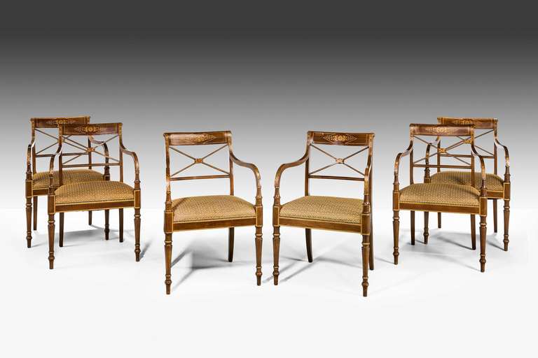 An elegant set of six parcel-gilt elbow chairs of George III design, the top rail splats and arms with soft gilded decoration, the stiles and uprights with gilded edges, the chairs style circa 1780 but made in the early 20th century.

RR.