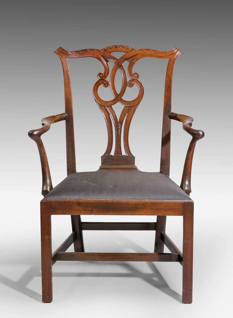 Chippendale Period mahogany Elbow Chair, the well carved interlaced splat with scrolls and foliage. Very shapely arms, the support of plain square section joined by a 