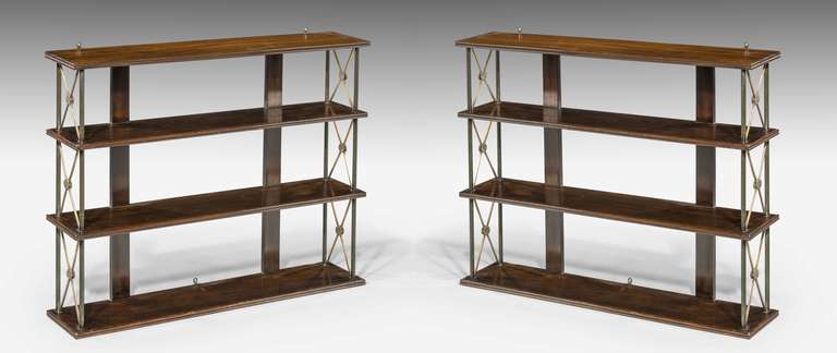 A Good Pair of 19th Century mahogany and bronze Hanging Shelves, the supports with 'X'shaped stretchers with floral motifs.

RR