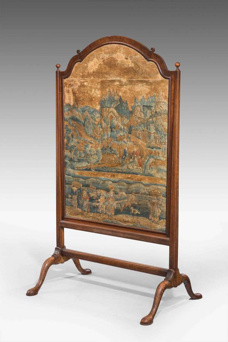 A George I period walnut Cheval Screen containing an interesting unfinished panel of petit point, with scenes of buildings in a mountainous landscape and country people, the simple elegant frame with an arched cresting and trestle legs joined by a