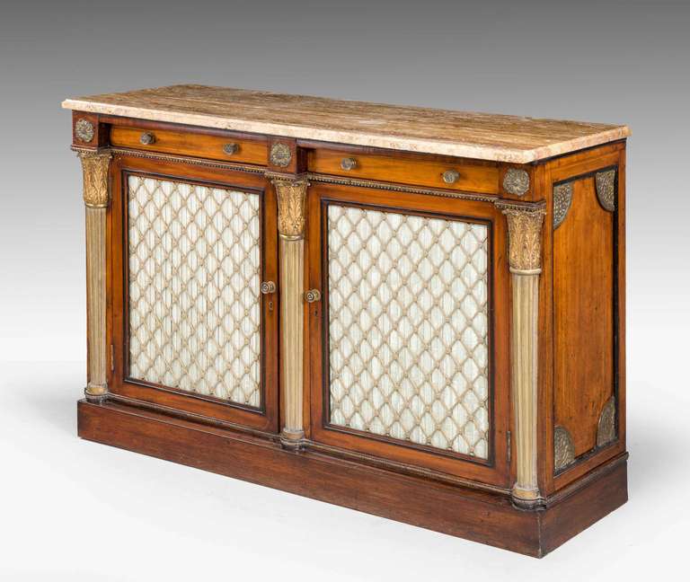 A fine Regency period mahogany side cabinet, with gilt bronze and parcel-gilt tapering columns, period diamond shaped grills, all finely cast and chiselled, unrestored condition.

RR.