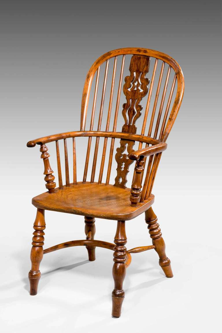 Early 19th century yew-wood Windsor armchair with crinoline stretcher, well figured but please note with spliced old repairs to the arms and restoration to the back rail.

The Windsor chair is established as one of the great classics of English