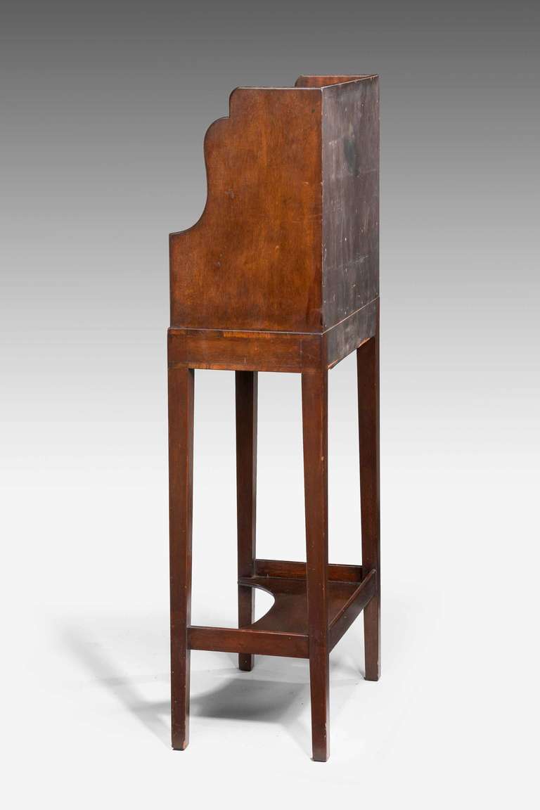 George III period mahogany cheveret, the upper section with four drawers and a single shelf over serpentine shaped supports, slender tapering legs with a concave shelf to the base.