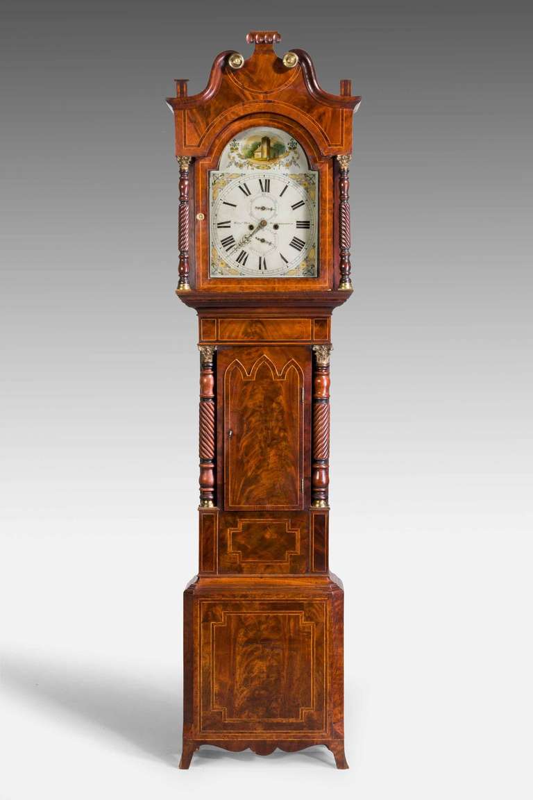 An attractive 19th Century mahogany Long case Clock by William Hay of Wolverhampton, eight day movement with two subsequent dials, painted rural scene to the face, finely figured case, tripe arched Gothic door, fine columns with gilt bronze mounts,