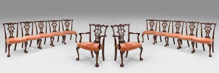 A quite exceptional set of 12 (ten side plus two arms) mahogany framed dining chairs of classical Chippendale design, the backs finely and elaborately carved with scrolls and foliage, the cabriole supports with anthemion carving to the knees