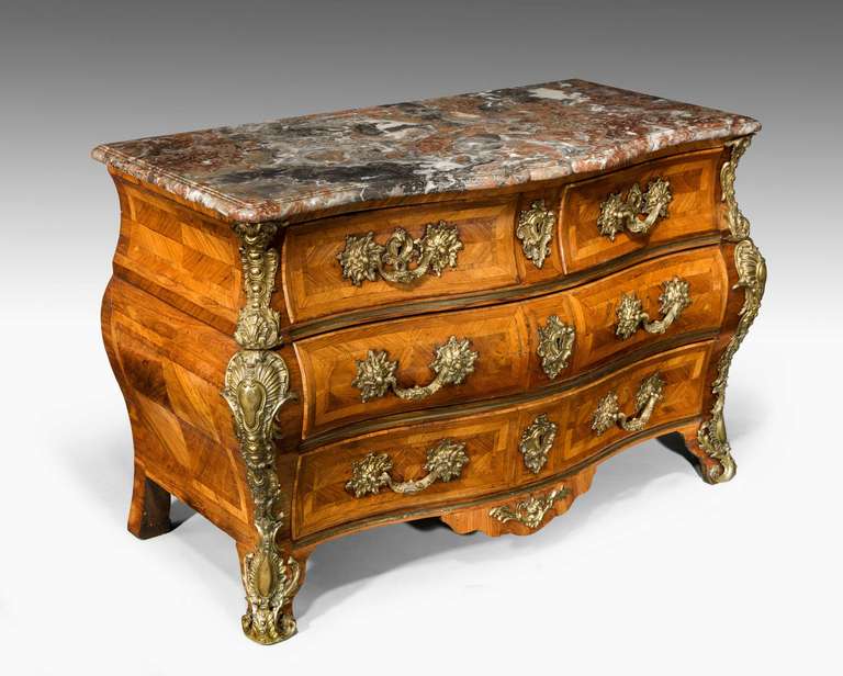 An exceptionally fine Louis XV Bombe Kingwood commode of exceptional color and patina retaining original period gilt bronze mounts and with a breche violette marble.