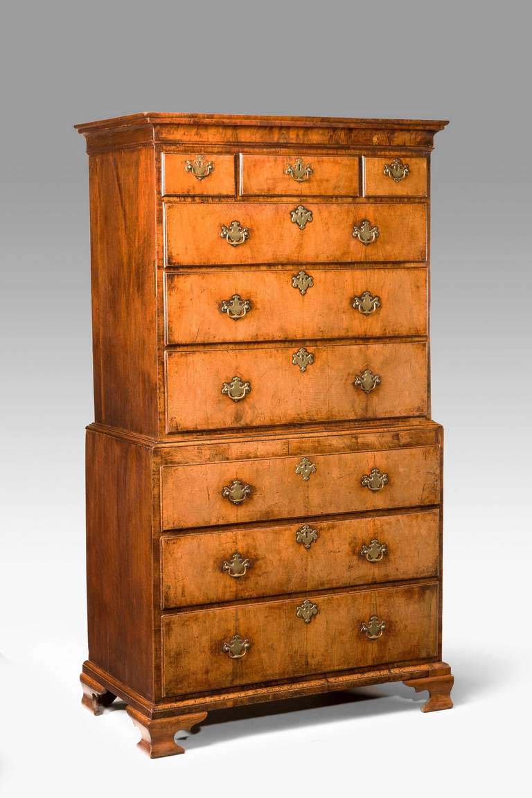 A George II period walnut tallboy, chest on chest, the top with a cavetto moulding supported on four ogee bracket feet.

