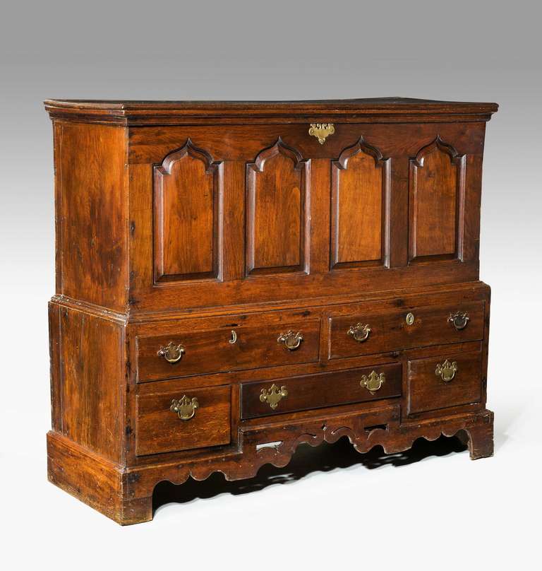 A mid-18th century oak mule chest, a very good color and patina with fielded arched panels.

