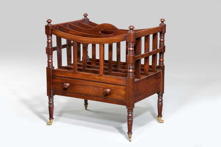 A Regency period mahogany canterbury with four upper sections, the freeze incorporating a single drawer with finely turned supports and period shoes and castors.

RR.