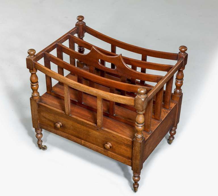 A Regency period mahogany Canterbury with four upper sections, the freeze incorporating a single drawer with finely turned supports and period shoes and castors.

RR.