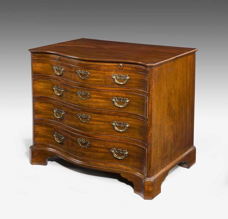 Late 18th Century Serpentine Mahogany Chest with canted corners and incorporating a brushing slide.