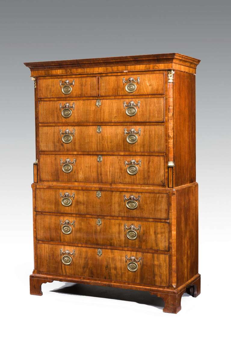 A very good George III period walnut chest on chest, the upper section incorporating quarter columns with gilt bronze mounts, the top section cross banded with a partial cavetto section and quite outstanding original gilt bronze mounts and