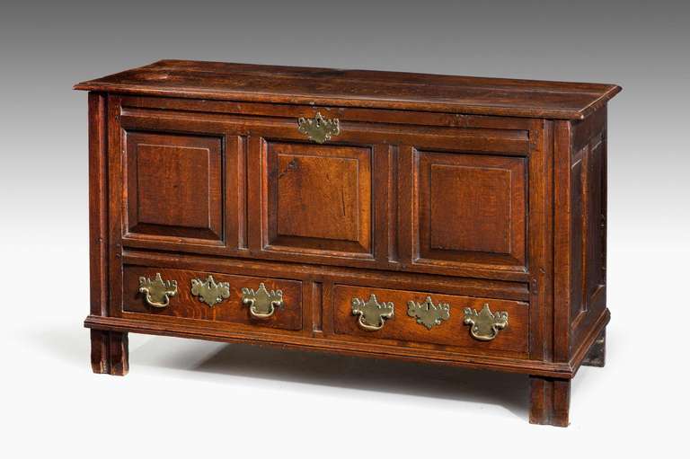A good late 18th century chest with three fielded panel fronts, well carved over two fitted drawers on original slender upright pillar supports.

RR.