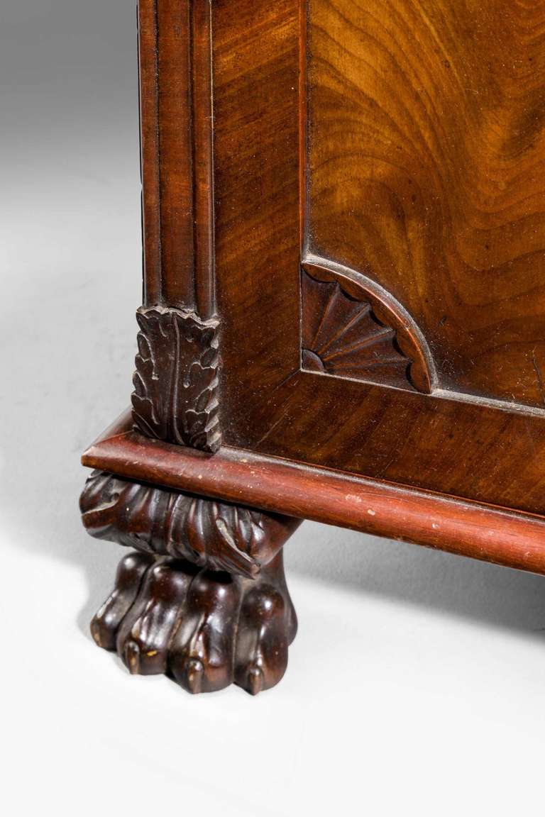 A good George III period mahogany pedestal cupboard, with well carved uprights top and bottom with anthemion detailing, exceptionally highly figured timbers to the fronts and very well carved hairy paw feet.

RR.