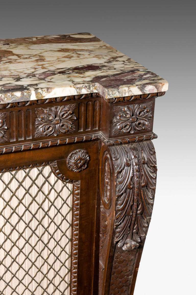 A 19th century North European side cabinet, the shaped anthemian supports either side of three well carved doors, finely carved freeze above a period marble top.

