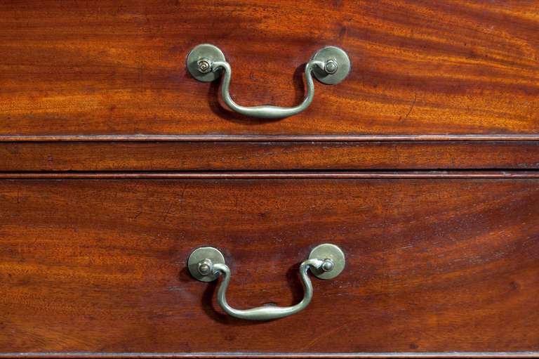 A good George III period straight fronted mahogany Chest of Drawers with original period handles standing on bracket feet with a moulded top edge.