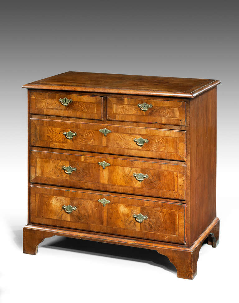 A good George II period walnut chest of drawers in very well figured timbers, the top with cross banded and herringbone inlay, the drawer fronts again with broad crossbanding and fine line herringbone inlay. The shaped bracket feet under a quarter