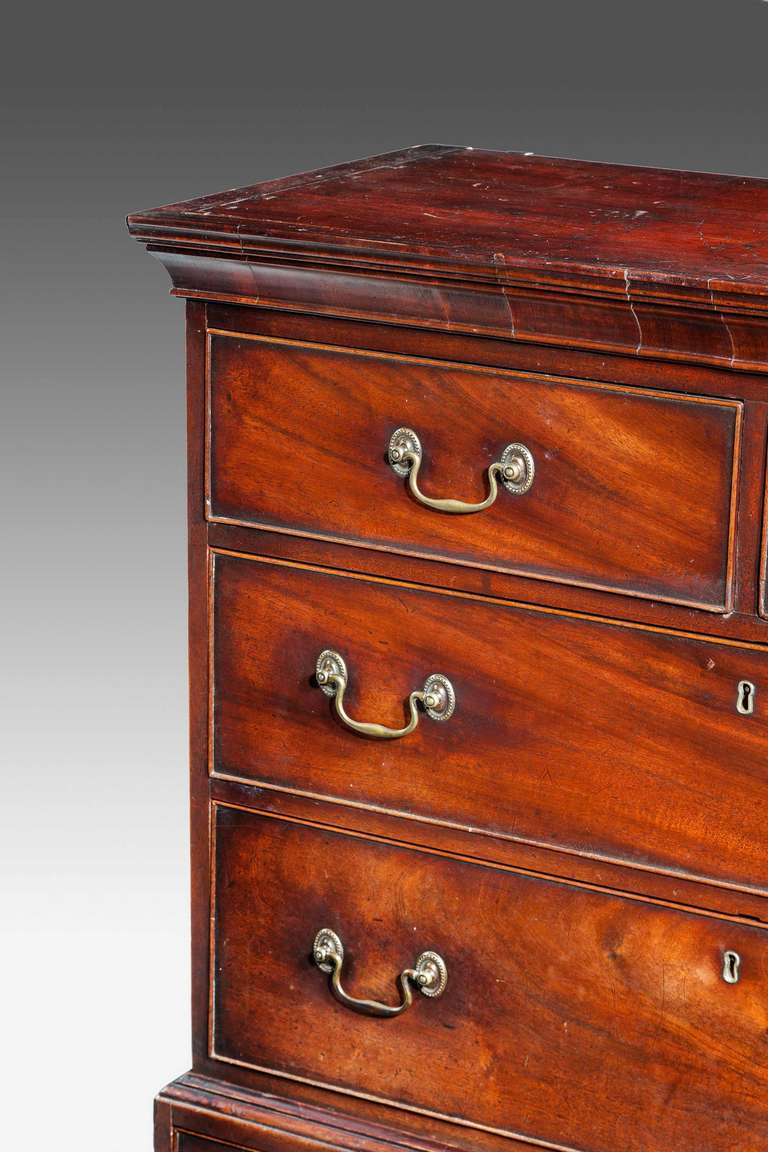 A most unusual George III period chest on chest of small proportions, the top section with a cavetto moulding, attractive and original swan neck brass handles.
These small chest on chests have always been historically connected with the small