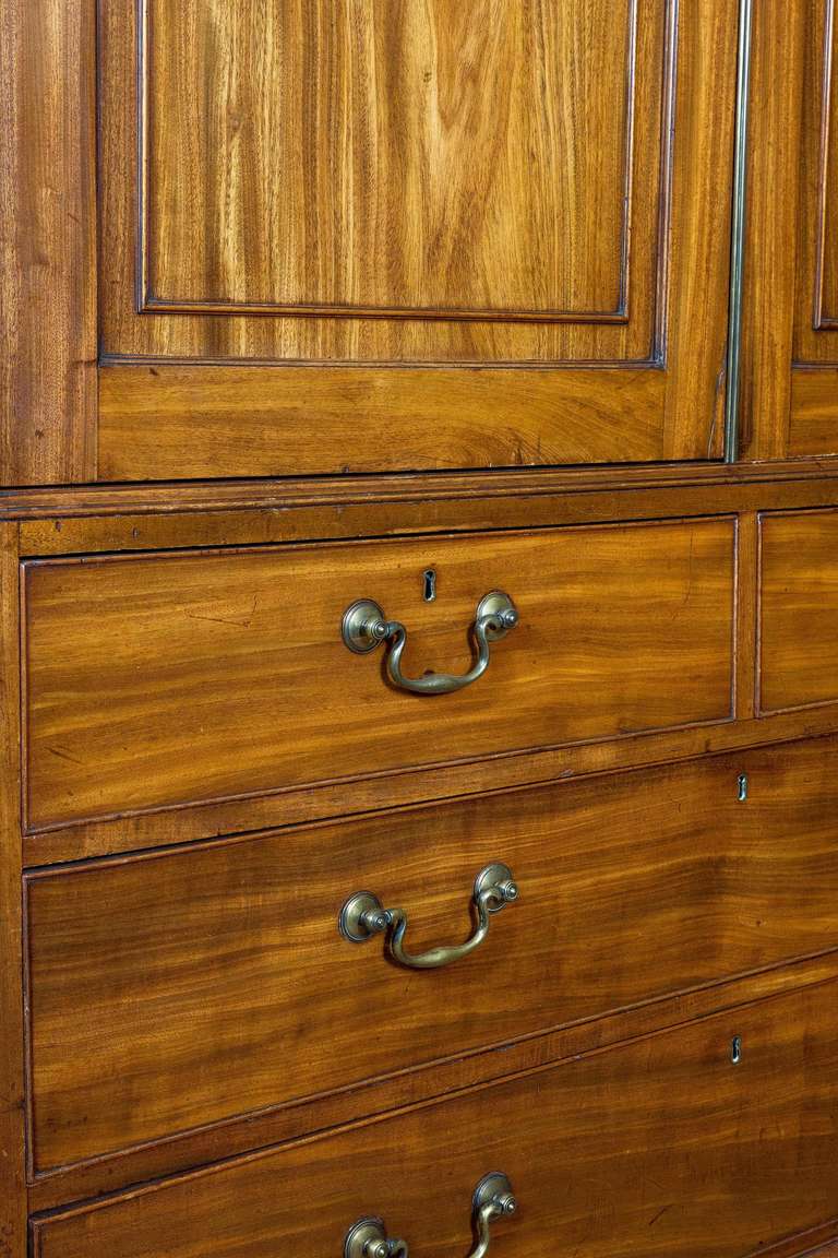 George III period Breakfront mahogany Wardrobe attributed to Gillows of Lancaster, the whole construction of the finest quality.The shaped top over a cross banded freeze, the doors highly figured with period swan neck handles to the base section,