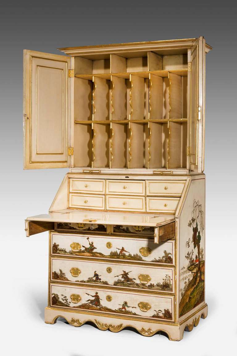 Early 18th century German chinoiserie lacquered bureau cabinet, the upper section with inset mirrored doors, the interior with six fitted drawers under a pair of candle slides. The surfaces with well executed panels of warriors and country scenes.