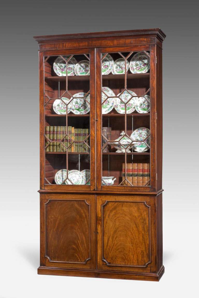 George III period mahogany, straight front, glazed top, bookcase with fielded panels to the base with finely figured timbers.

RR.