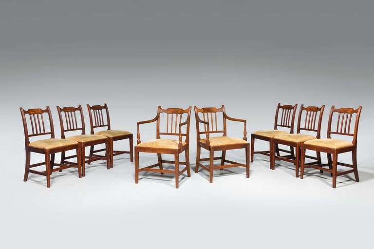 Set of eight (six side plus two arm) George III period mahogany framed dining chairs, the top splats with contrasting flame timbers on a finely turned armrest and square tapering feet.


