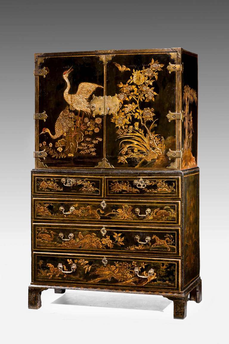 A Charles II period lacquered Cabinet on Chest. Very well decorated with oriental scenes incorporating cranes and exotic foliage, the interior beautifully fitted with ten drawers similarly decorated.