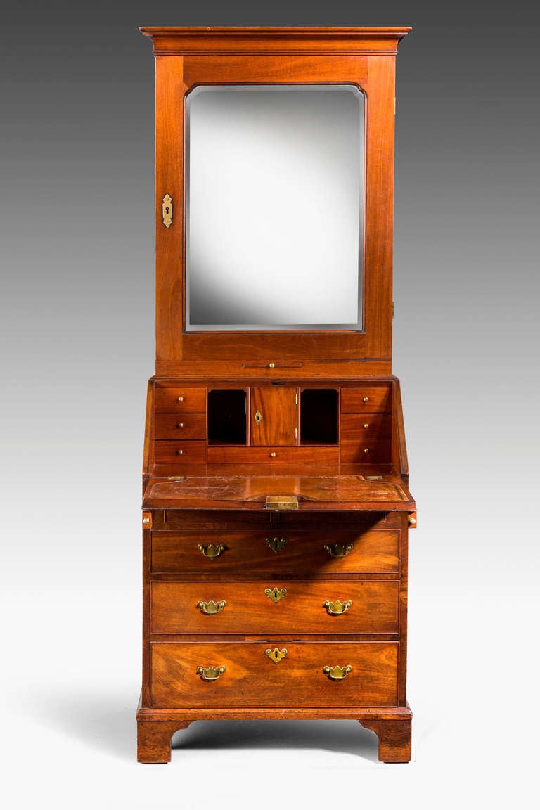 Chippendale period mahogany Bureau Bookcase of a lovely faded colour and good proportions, the interior with pigeon holes and drawers, an original tooled leather writing surface, replaced mirror plate.

