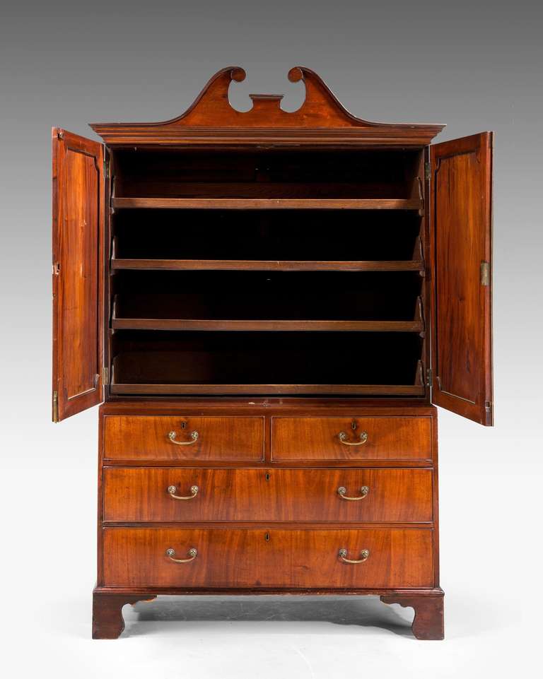 George III period mahogany Press with a swan neck pediment, the interior with five original sliding trays, well figured matching doors to the upper section.