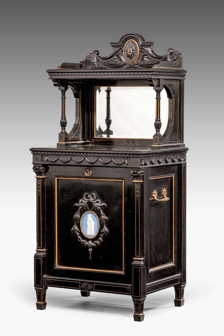 An ebonized mahogany, bone inlaid podium mounted with a Wedgwood style neoclassical oval plaque.

RR.