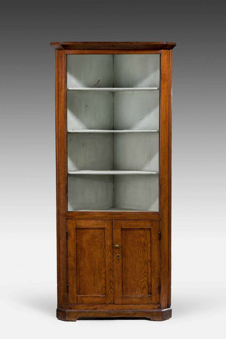 Late 18th century oak open standing corner cupboard, the base section with a single shelf.