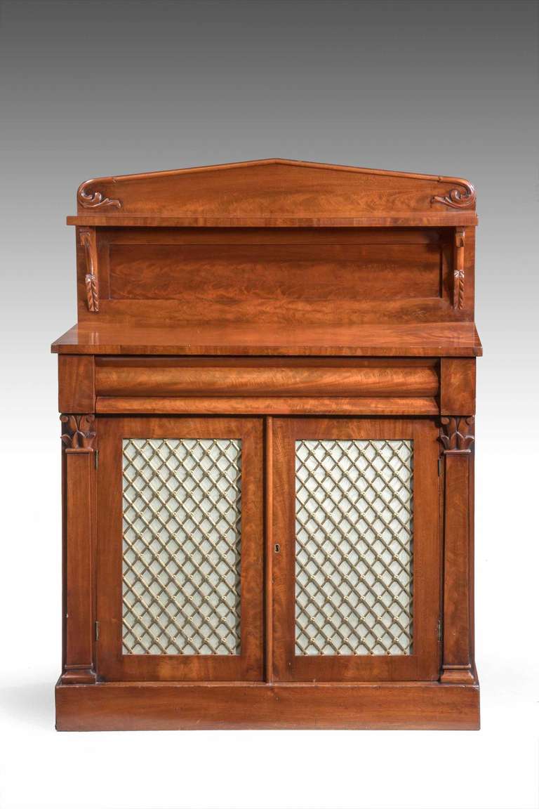Late Regency period mahogany Chiffonier of small proportions, shaped top drawer, beautifully figured top section, half pilaster supports with fine brass grills.

 