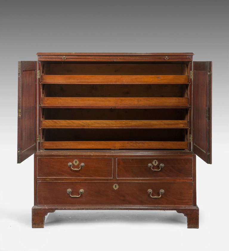 George III period mahogany Dwarf Press of unusual form incorporating four slides to the top section internally, above a brushing slide set into the cabinet, broadly crossbanded.

RR.