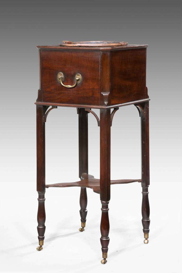 An unusual George III period mahogany Jardiniere on square section and turned supports with an inset copper liner.