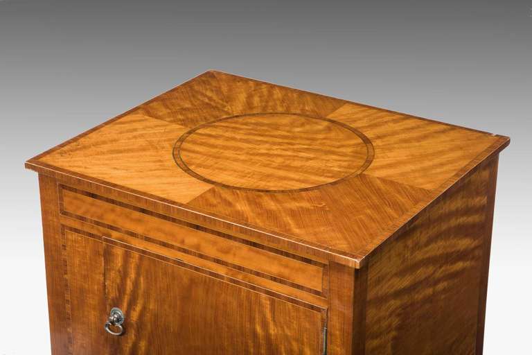 19th Century Satinwood Cupboard of small proportions, the quartered top with a highly figured centre section.