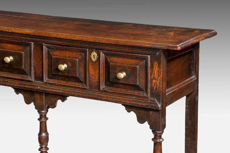 A late 17th century oak dresser, the turned supports terminating in block feet, triple drawer to the front with fielded panels, very good patina and color.

In the 19th century various different styles of ceramics would evolve to fill the plate