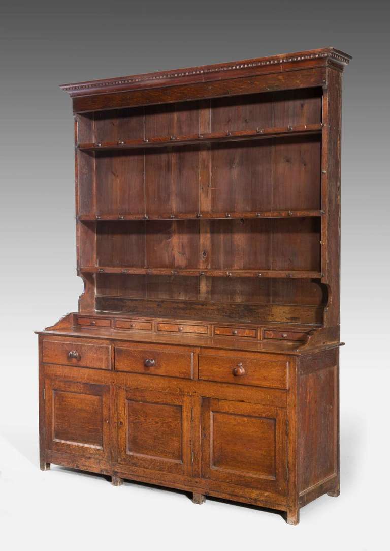 An attractive late 18th century dresser and rack, the top incorporating five spice drawers, recess panels to the base section.

A Welsh dresser sometimes known as a kitchen dresser or pewter cupboard, is a piece of wooden furniture consisting of