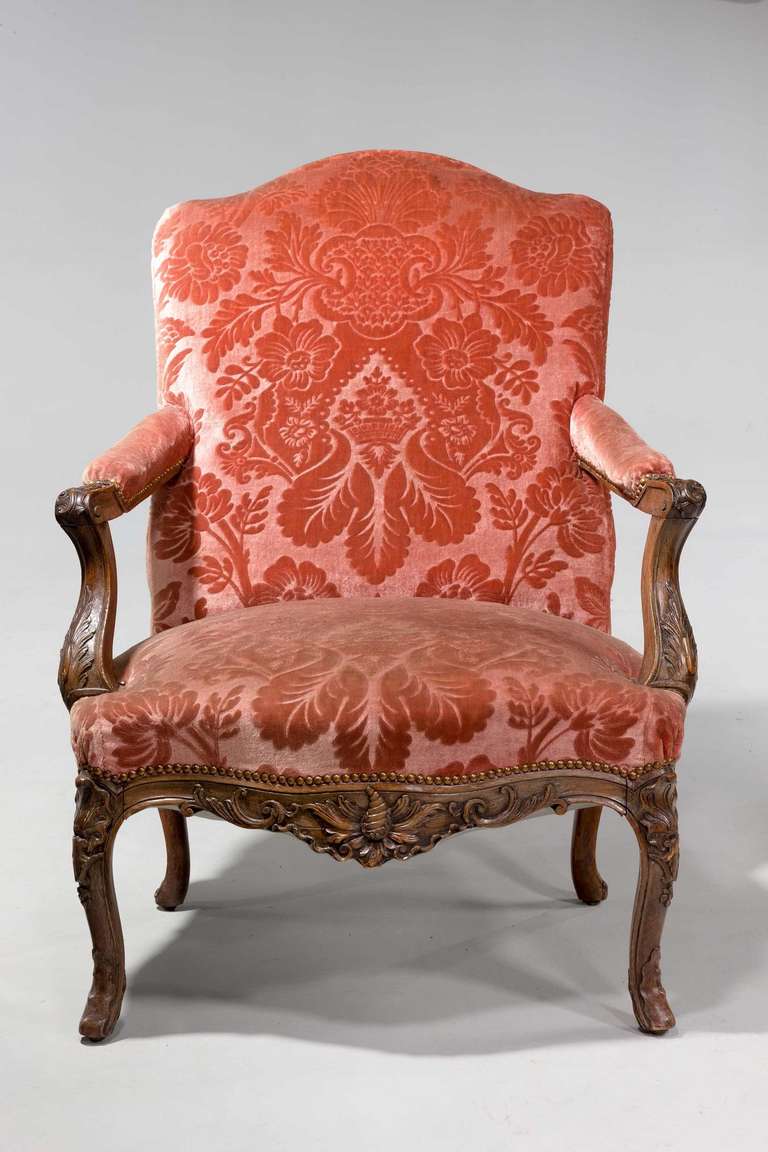 A good pair of 19th century beech fauteuil of Louis XIV design, of generous proportions, the frames and the front aprons carved with shells foliage and scrolls on cabriole supports.

A fauteuil is a style of open armchair with a primarily exposed