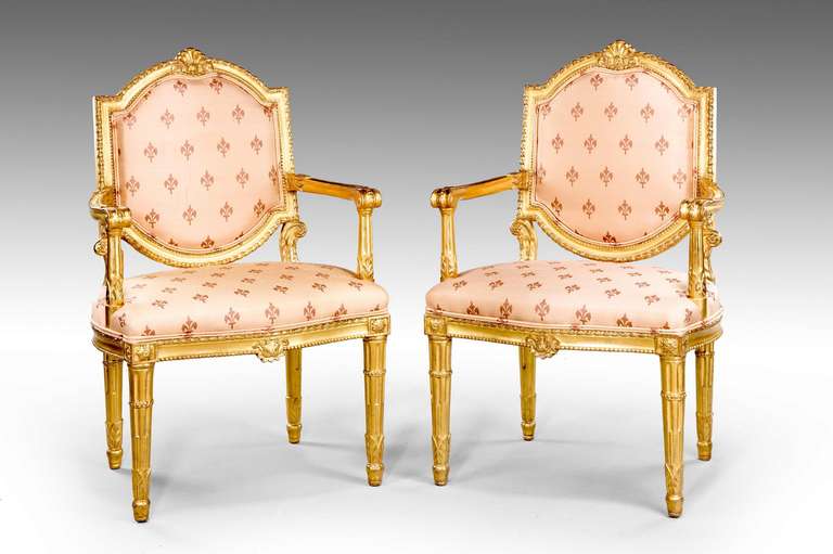 A pair of giltwood Italian Elbow chairs with well carved edge decoration.

