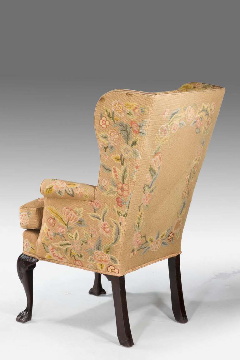 A fine mid-18th century mahogany framed wing chair of very small proportions on high well carved cabriole supports. Fine but somewhat tired 19th century tapestry upholstery in very muted shades.

Provenance
An 18th or 19th century wing chair is
