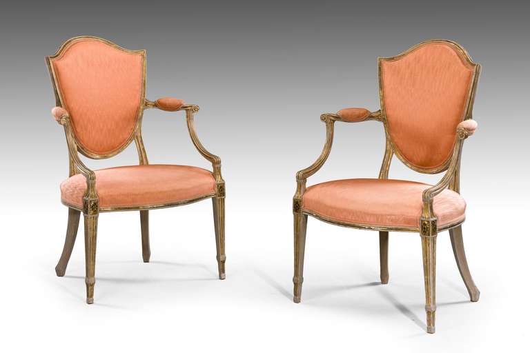 A set of four George III period parcel-gilt armchairs, the façade with incised gilded decoration, the supports square section, tapering. The paintwork and gilding somewhat tired. Also available as two pairs if required.