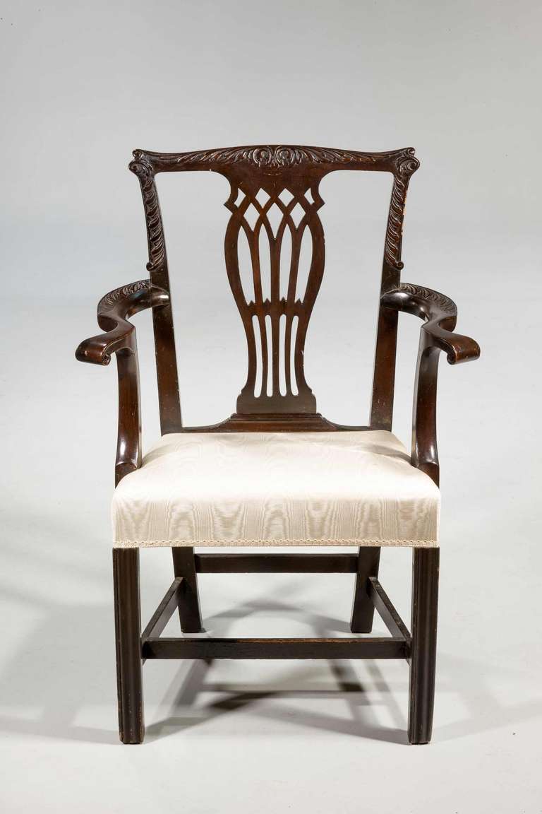 Chippendale design mahogany armchair with intricate splat standing on square supports united with a stretcher.

RR.