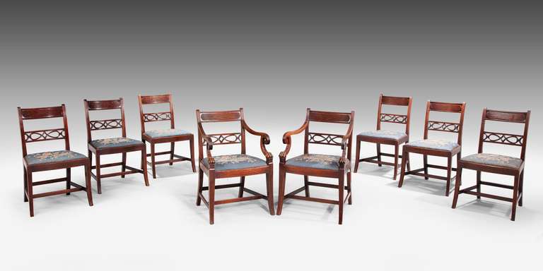A good and original set of eight (six + two) George III period mahogany chairs, the elaborately swept arms terminating in curls, the gently sabre supports which reeded decoration, the finely pierced and carved back splats.
