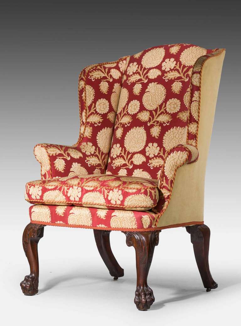 George II period wing chair of good proportions, cabriole supports with scroll work to upper section.