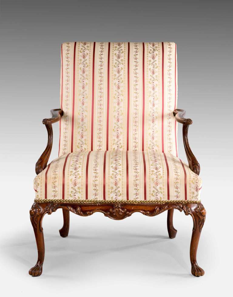 A beech framed late 19th century Gainsborough armchair, the timber shaded to mahogany, delicately carved front rail on cabriole supports.

Provenance:
A Gainsborough armchair (also known as a Martha Washington chair in the United States) is a type